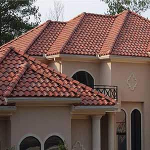 Close-up of a large mid-class residential home with red-ish Boral tiles on its roof