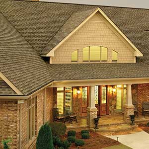 Mid-class residential home with brown GAF shingles on its roof